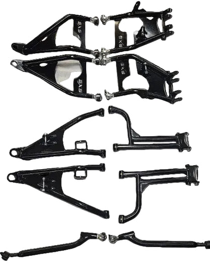 A set of black metal suspension and control arm parts laid out on a white sheet of paper, with some silver hardware visible